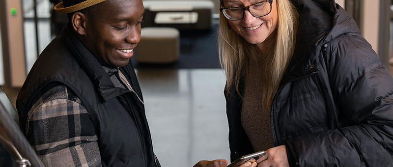 Two persons looking at a phone