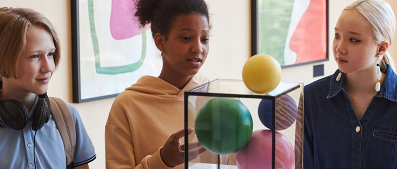 Kids looking at an object at a museum