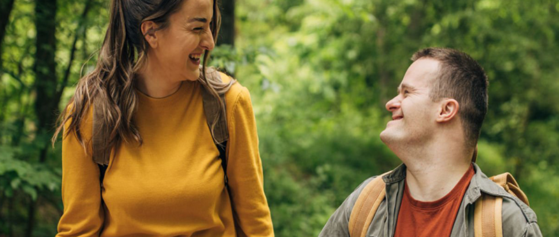 Assistant laughing with care recipient