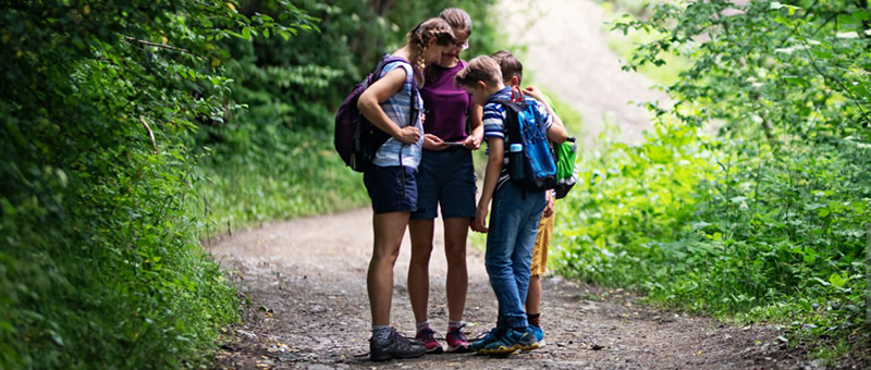 Kids playing app game in nature